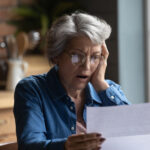 woman looking at hospital bills