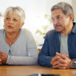 Senior couple, documents and listening to lawyer for retirement plan, finance or investment at home. Mature man and woman with attorney for budget planning, paperwork or legal agreement together