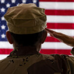 Female Soldier saluting the American Flag